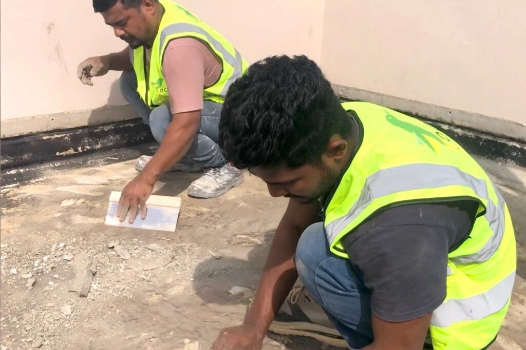Removing gravel and existing roof build-up during waterproofing investigation.