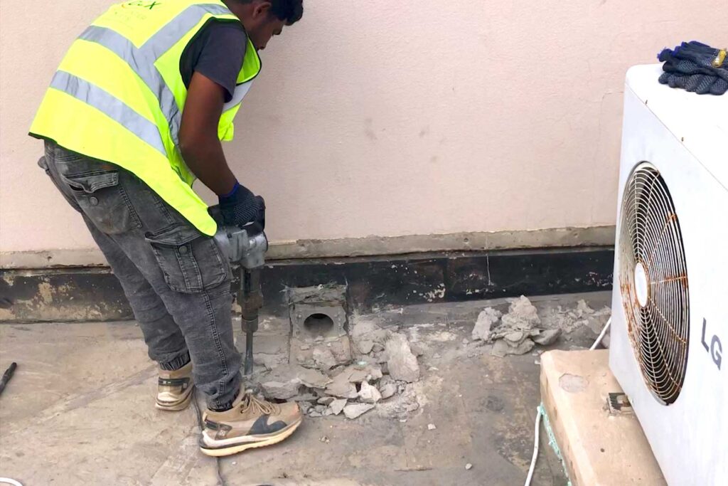 Dismantling damaged roof drainage outlet and waterproofing chamber