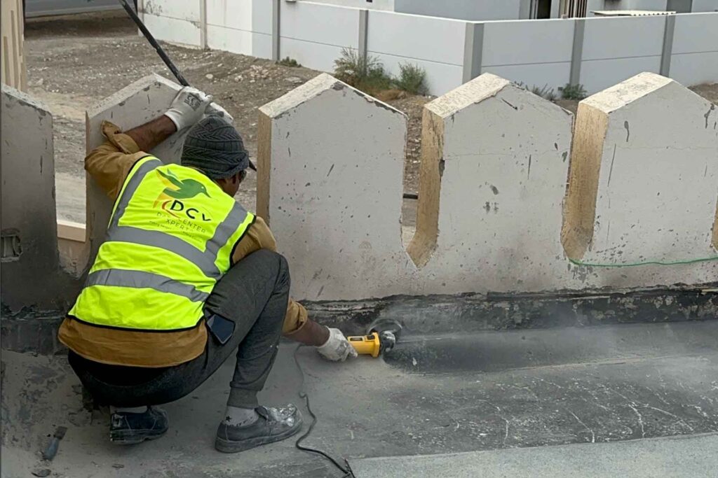 Waterproofing treatment around roof wall junctions and penetrations at Omar Bin Al Khattab Mosque during roof leak rectification project.