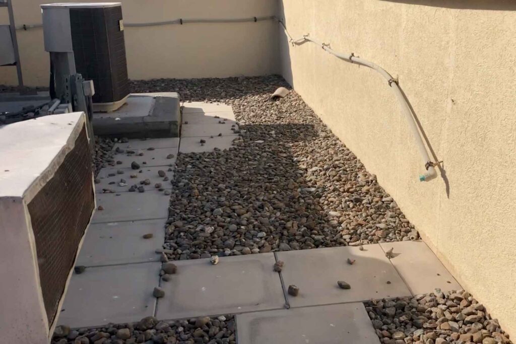 Failed roof waterproofing system with deteriorated screed and drainage chamber requiring FOSROC waterproofing restoration in Dubai.