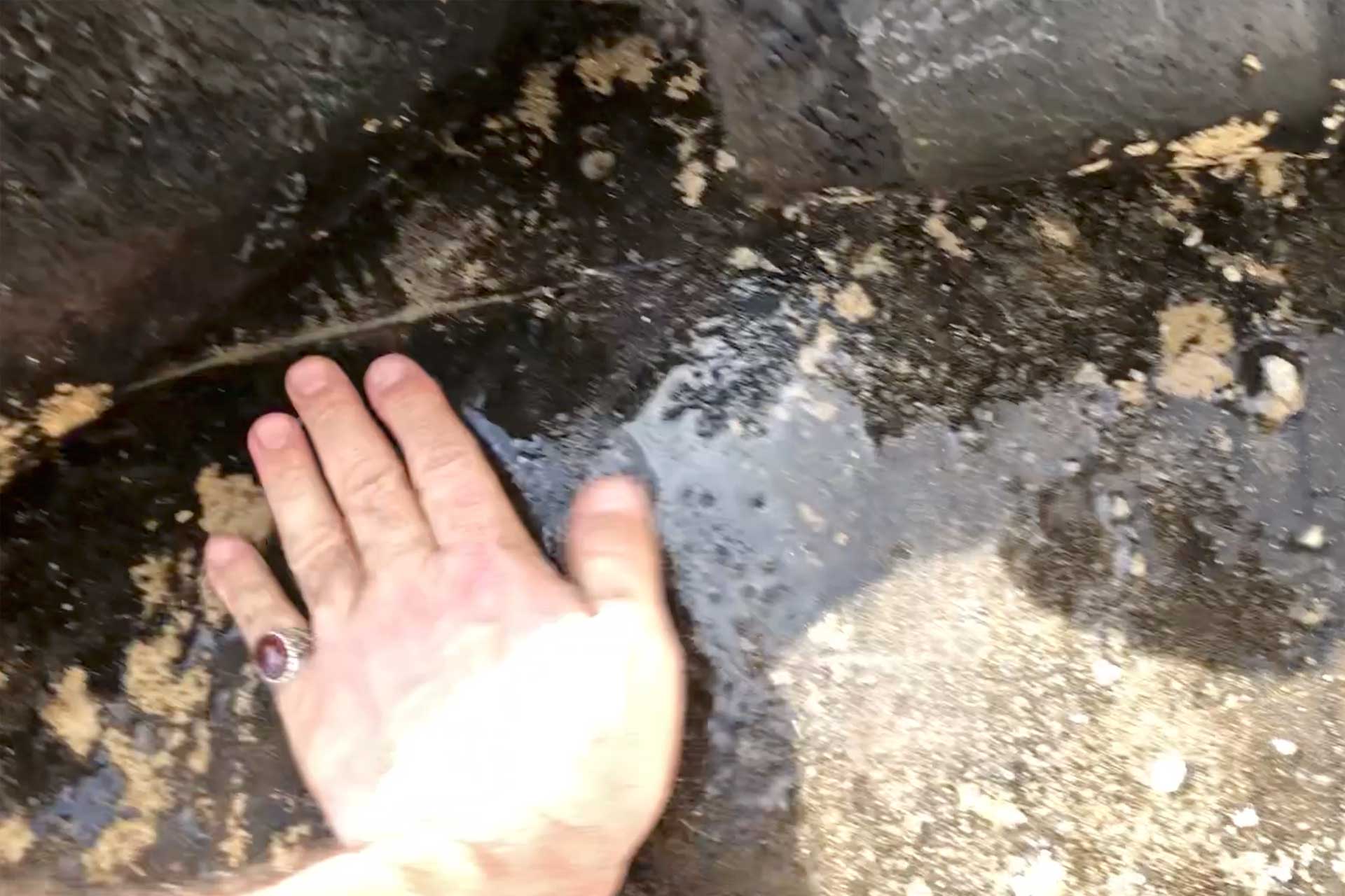 Engineering inspection identifying water ingress beneath the existing waterproof membrane during villa roof waterproofing investigation in Dubai.